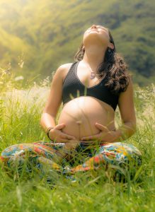 Power Birthing pregnant woman sitting in nature